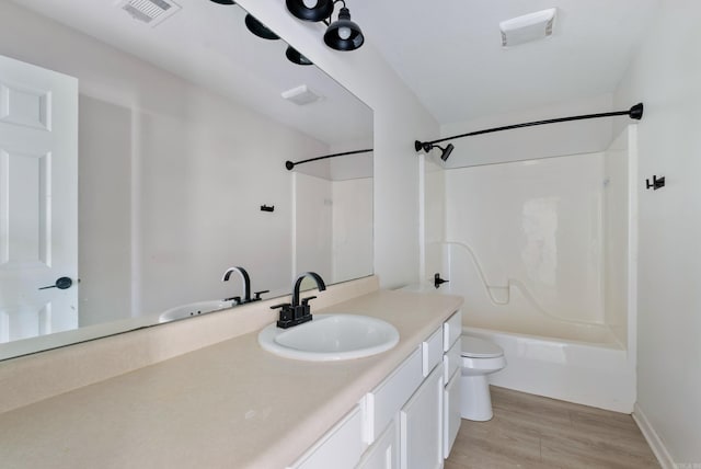 full bathroom featuring shower / bathing tub combination, toilet, vanity, and hardwood / wood-style flooring