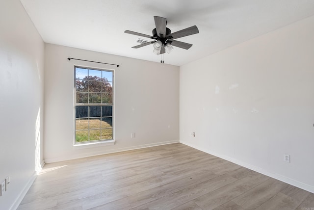 spare room with ceiling fan and light hardwood / wood-style flooring