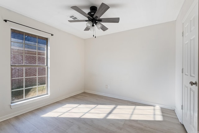 spare room with ceiling fan and light wood-type flooring