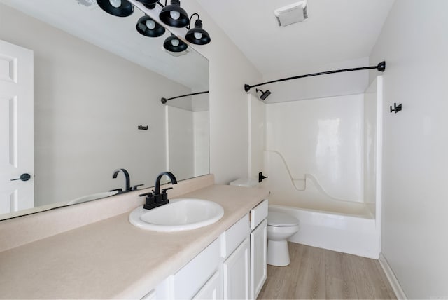 full bathroom with hardwood / wood-style flooring, vanity, toilet, and bathing tub / shower combination