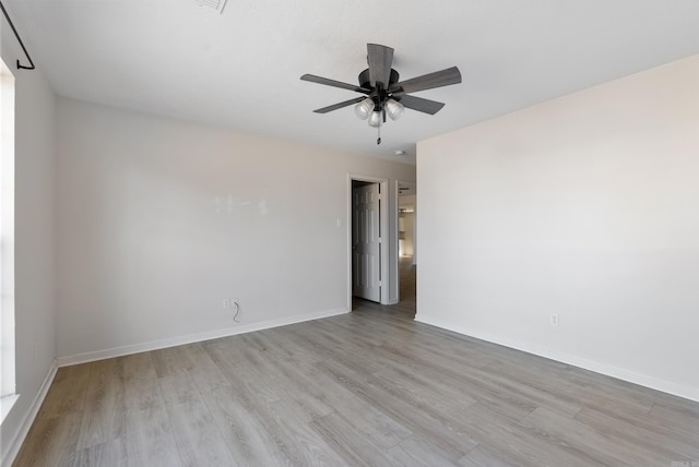 empty room with ceiling fan and light wood-type flooring