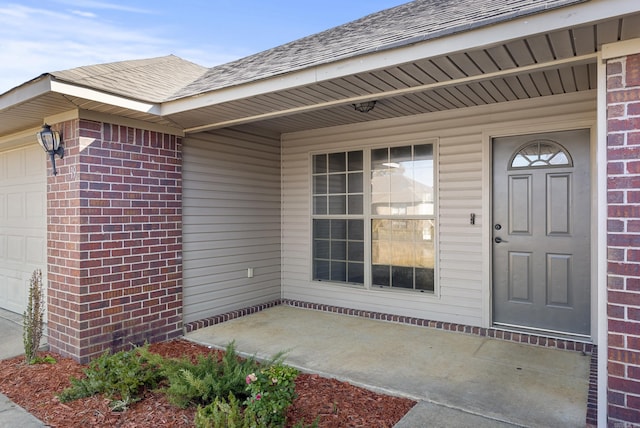 doorway to property featuring a garage