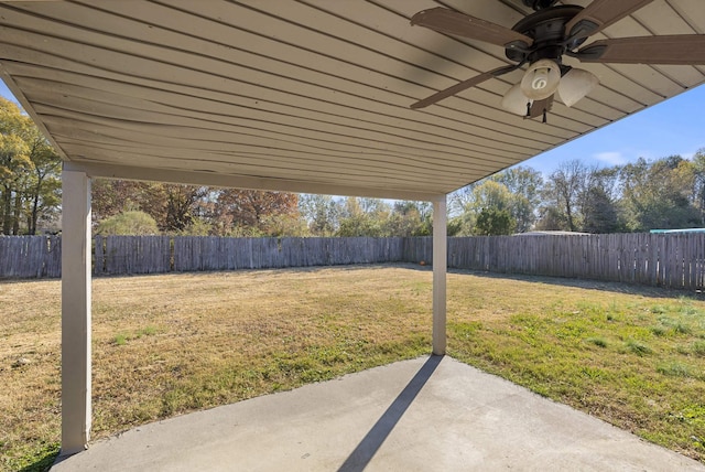 view of yard with ceiling fan and a patio