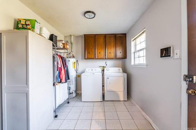 clothes washing area with cabinets, water heater, independent washer and dryer, a textured ceiling, and light tile patterned floors