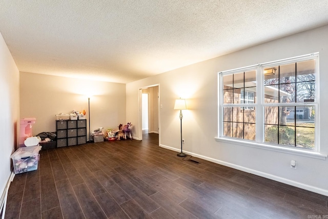 interior space featuring dark hardwood / wood-style flooring and a textured ceiling