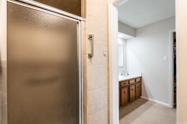 bathroom with vanity and a shower with door