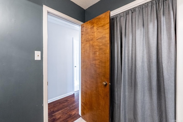 interior space with dark hardwood / wood-style flooring and a textured ceiling