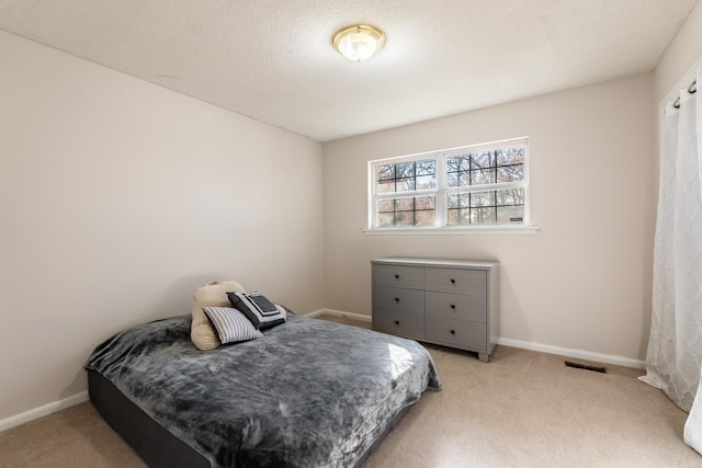 carpeted bedroom featuring a textured ceiling