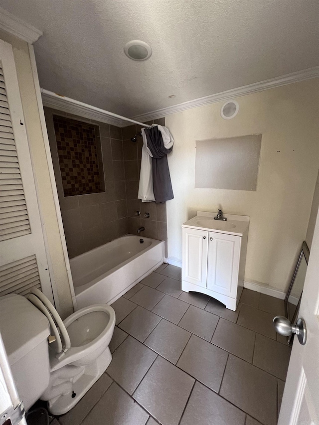 full bathroom with tile patterned flooring, crown molding, a textured ceiling, toilet, and tiled shower / bath