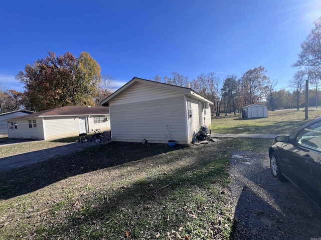 view of property exterior featuring a storage shed