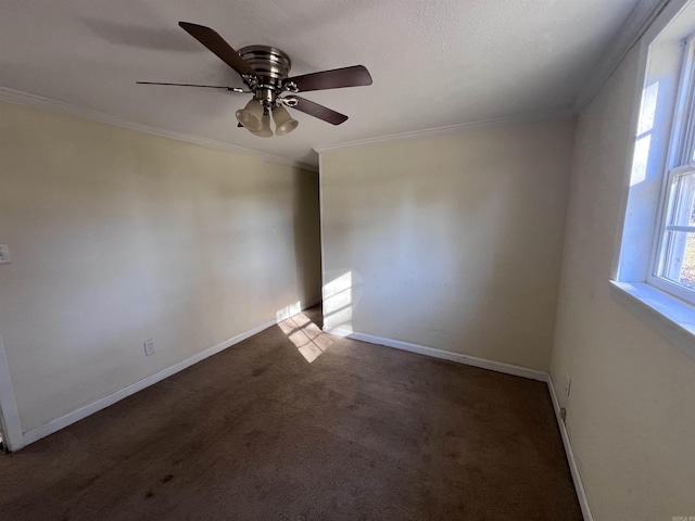carpeted spare room featuring ceiling fan and ornamental molding