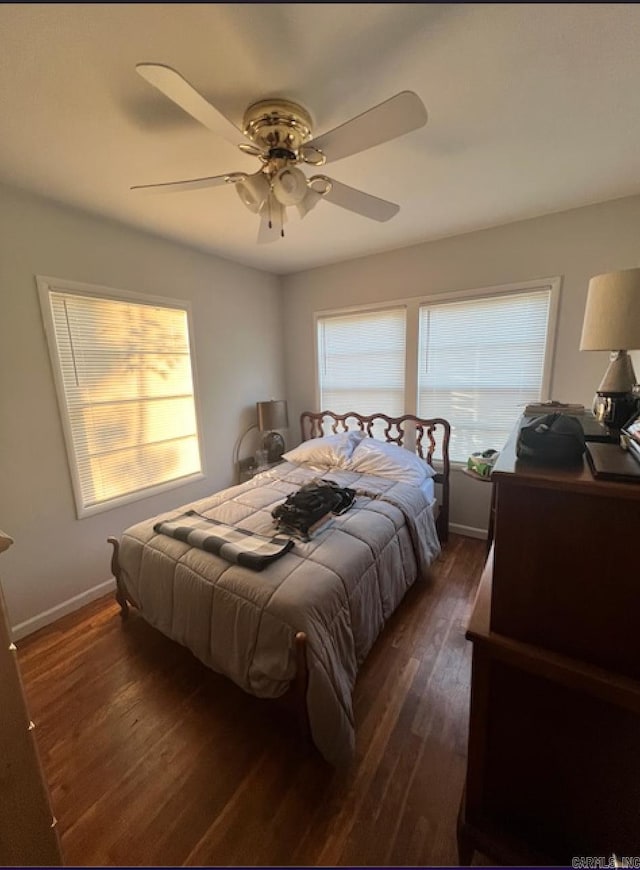 bedroom featuring multiple windows, ceiling fan, and dark wood-type flooring