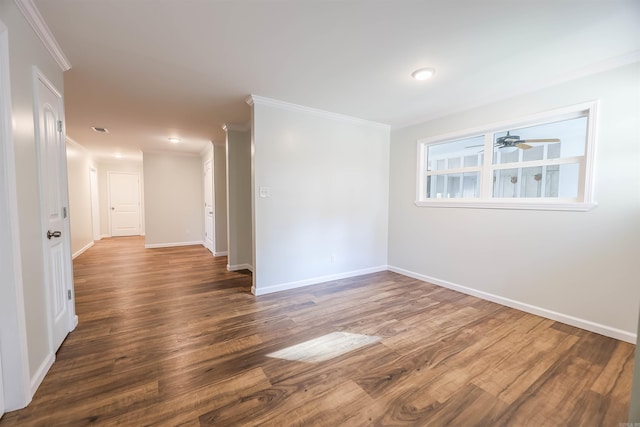 unfurnished room with crown molding, ceiling fan, and dark hardwood / wood-style floors