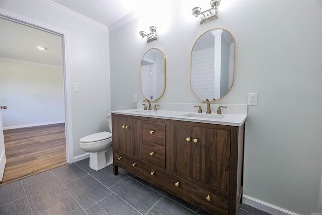 bathroom featuring hardwood / wood-style floors, vanity, toilet, and crown molding