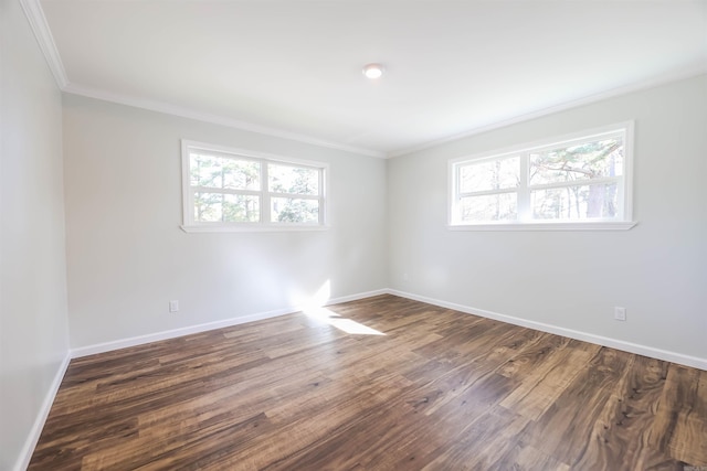 empty room featuring ornamental molding and dark wood-type flooring