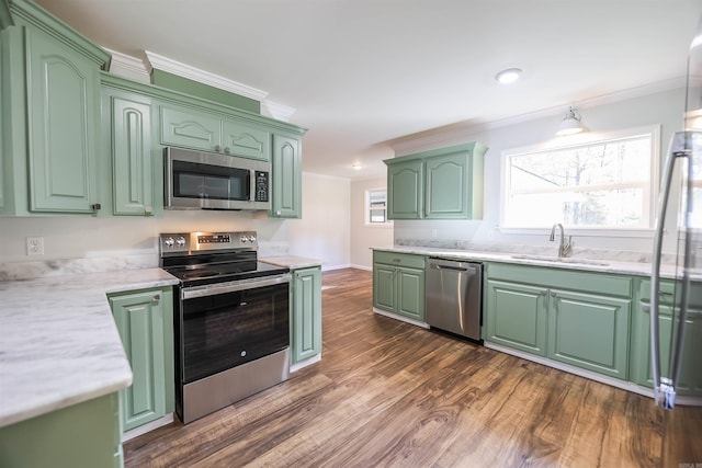 kitchen with dark hardwood / wood-style flooring, stainless steel appliances, green cabinets, and sink