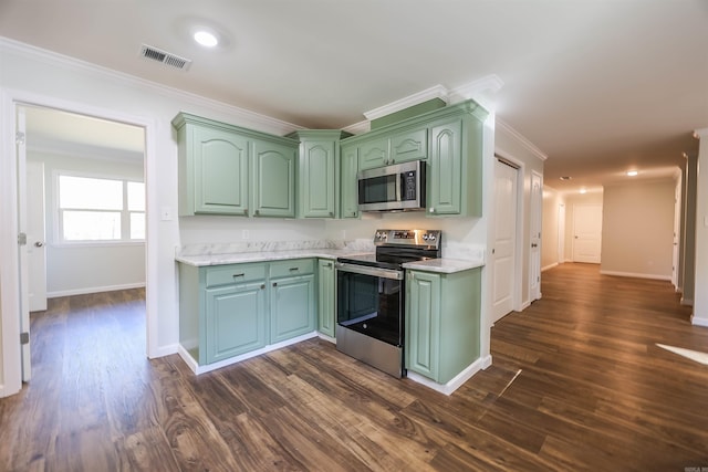 kitchen featuring green cabinetry, ornamental molding, stainless steel appliances, and dark wood-type flooring