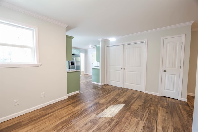 interior space featuring dark hardwood / wood-style flooring and ornamental molding