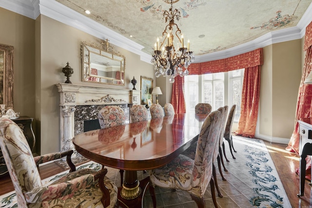 dining space featuring wood-type flooring, an inviting chandelier, ornamental molding, and a premium fireplace