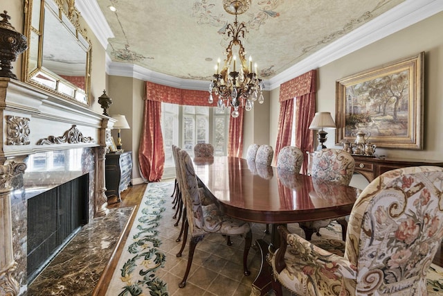 dining space with a notable chandelier, dark hardwood / wood-style floors, ornamental molding, and a high end fireplace