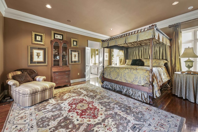 bedroom featuring hardwood / wood-style flooring, crown molding, and ensuite bath