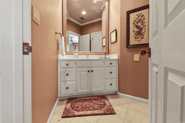 bathroom with tile patterned floors, vanity, and crown molding