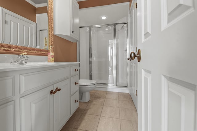 bathroom featuring tile patterned flooring, vanity, ornamental molding, and walk in shower