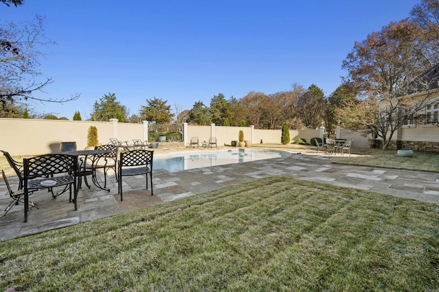 view of yard featuring a fenced in pool and a patio