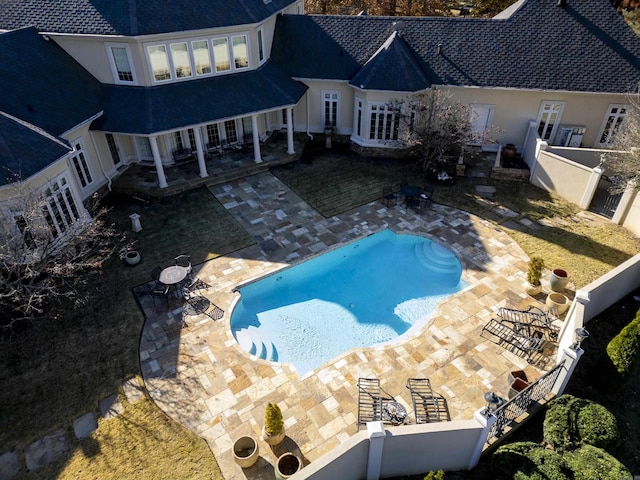 view of swimming pool with a patio area and french doors