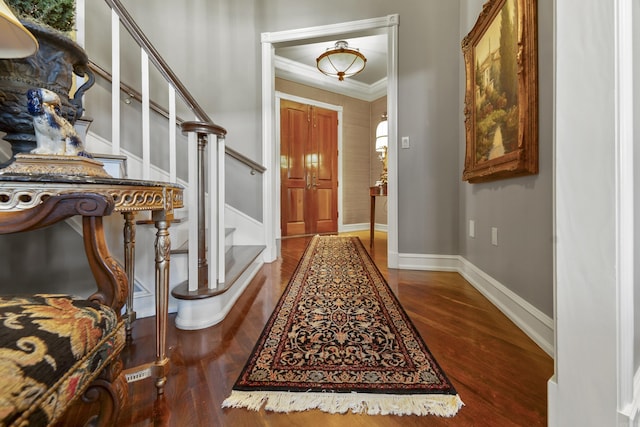 entryway featuring dark hardwood / wood-style floors and crown molding