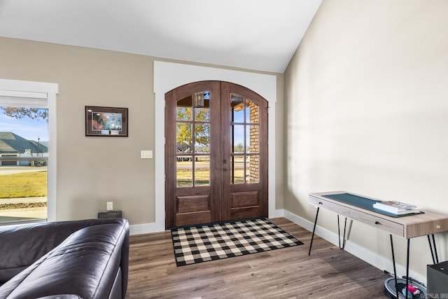 foyer entrance featuring french doors, wood-type flooring, and lofted ceiling