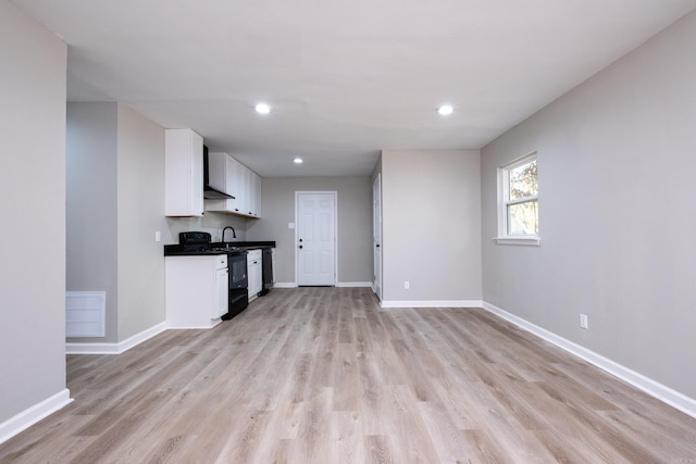 interior space featuring sink and light hardwood / wood-style flooring