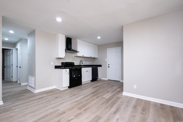 kitchen featuring black appliances, white cabinets, sink, light hardwood / wood-style flooring, and wall chimney exhaust hood