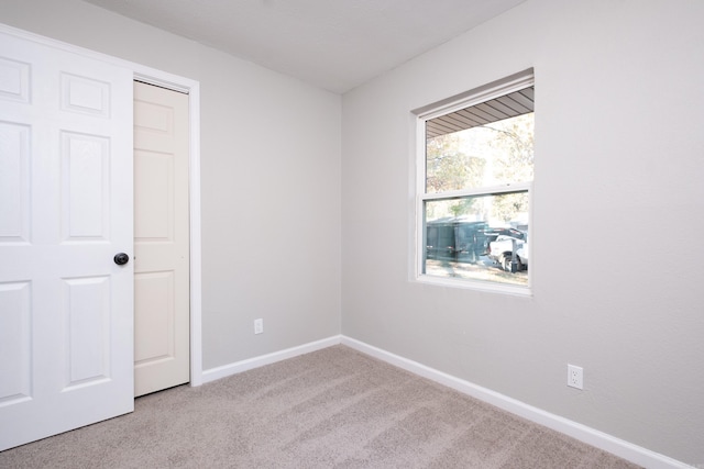 unfurnished bedroom featuring light colored carpet