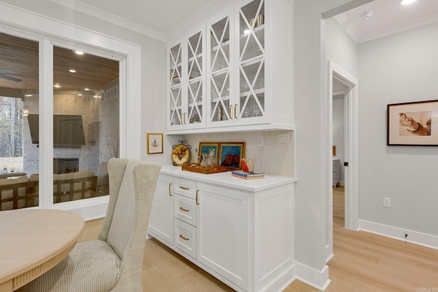 interior space with crown molding and light wood-type flooring