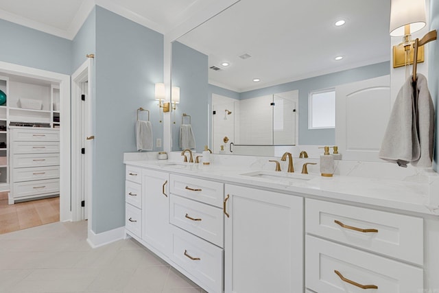 bathroom with vanity, tile patterned floors, a shower with shower door, and crown molding