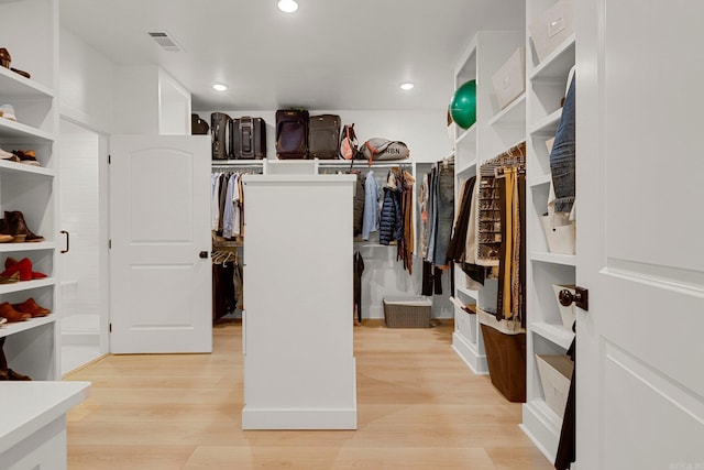 spacious closet with light hardwood / wood-style floors