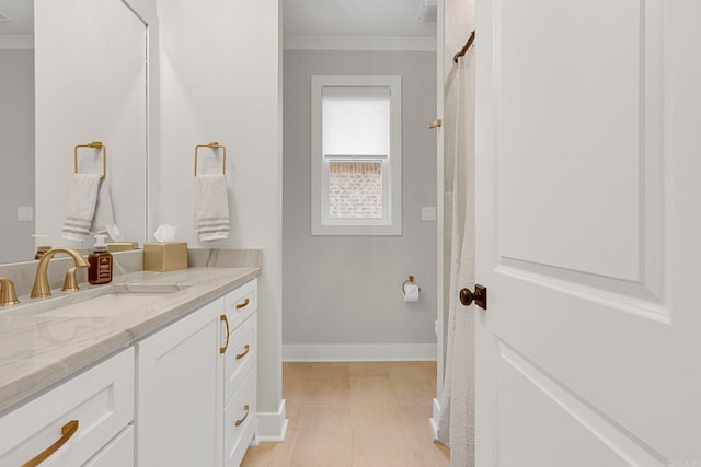 bathroom with vanity and ornamental molding