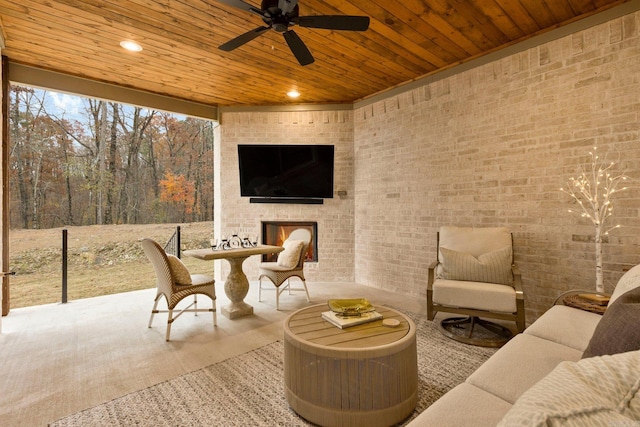 view of patio featuring an outdoor living space with a fireplace and ceiling fan