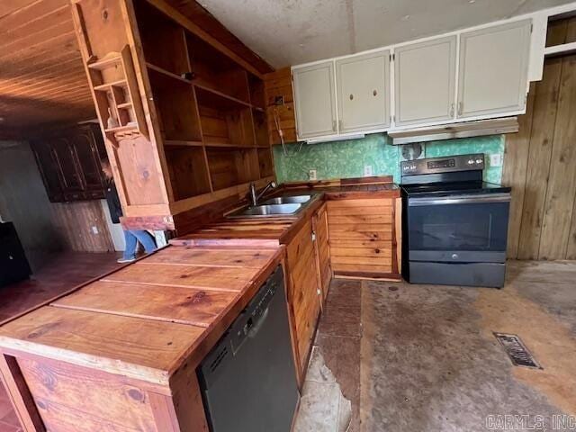 kitchen featuring stainless steel dishwasher, black range with electric cooktop, sink, concrete floors, and white cabinetry