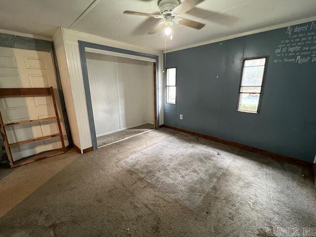 unfurnished bedroom with ceiling fan, a closet, and carpet floors