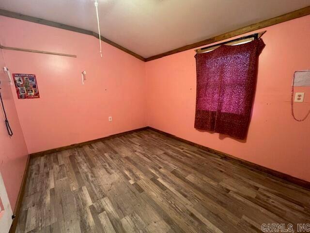 spare room with wood-type flooring and ornamental molding