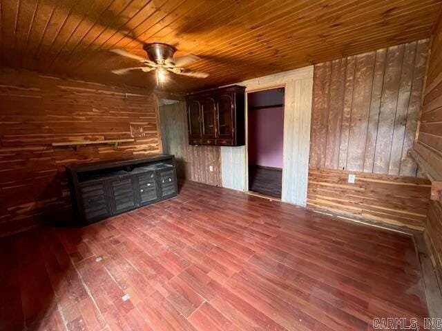 unfurnished bedroom with wood walls, wood ceiling, and hardwood / wood-style flooring