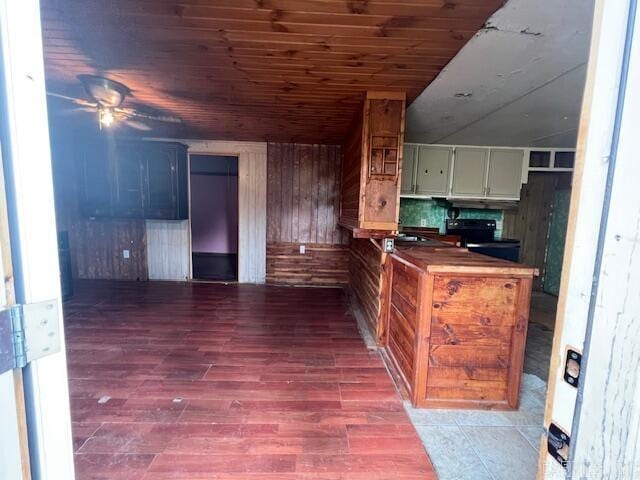 kitchen with hardwood / wood-style flooring, wood counters, wooden ceiling, and wooden walls