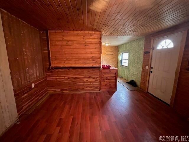 foyer entrance with wood walls, wood ceiling, and hardwood / wood-style flooring