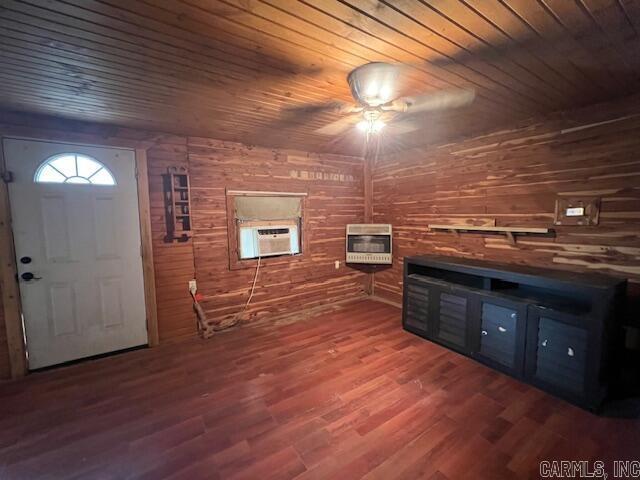 entrance foyer featuring ceiling fan, wooden ceiling, heating unit, hardwood / wood-style floors, and wooden walls