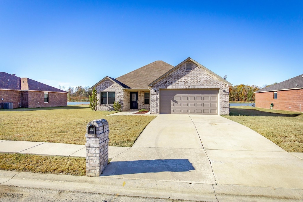 view of front of property featuring a garage and a front lawn