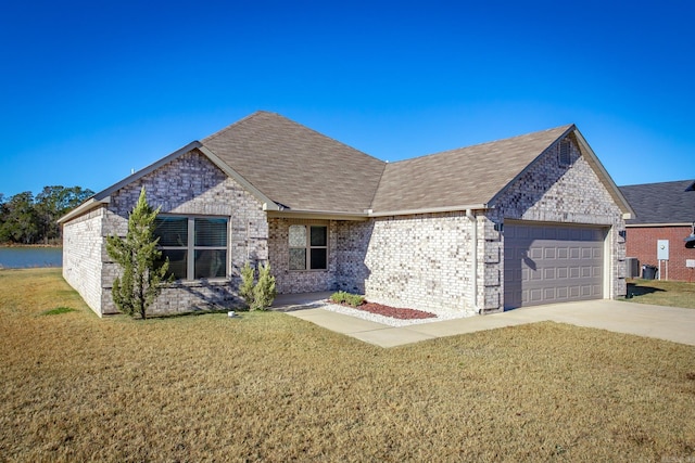 view of front of house with a front lawn and a garage