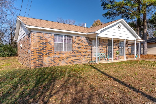 view of front of home with a porch and a front yard