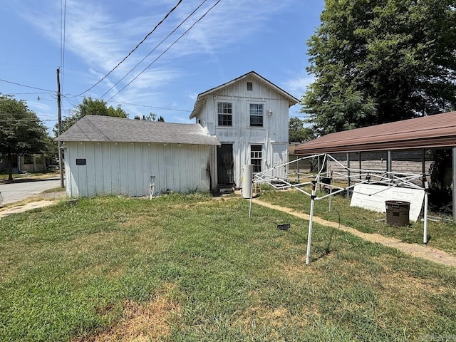 rear view of property with an outbuilding